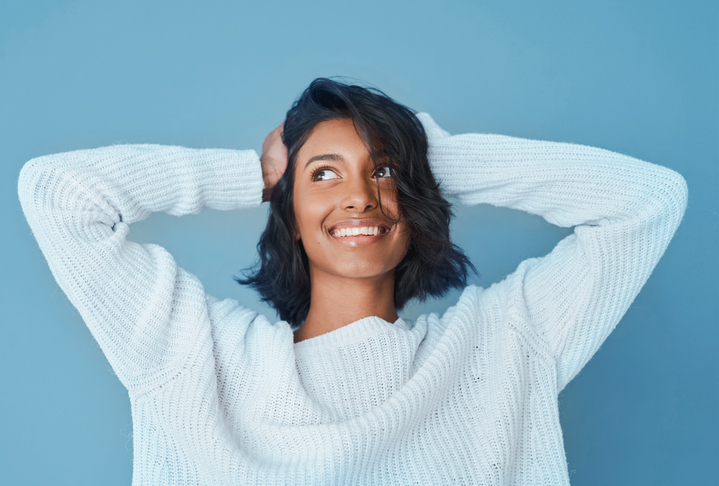 smiling young woman in white sweater